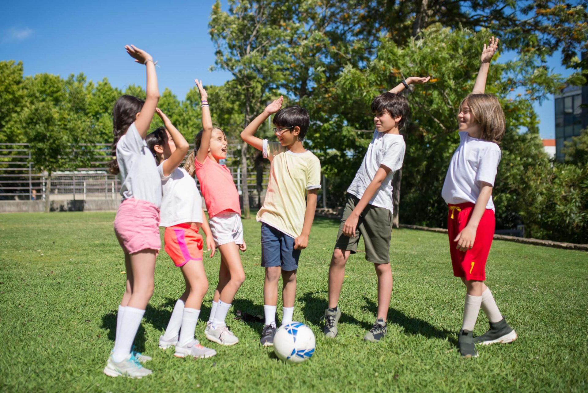 kids high fiving each other during a soccer game